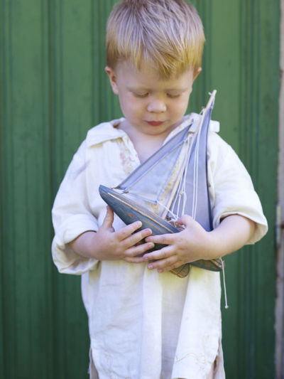 Boy with sailing boat toy