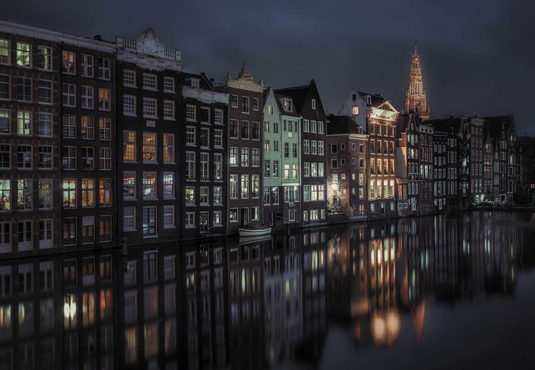 Reflection of buildings in water at night