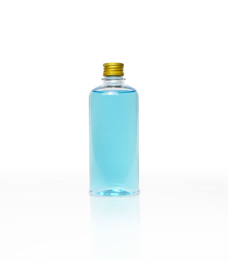 Close-up of glass bottle against white background