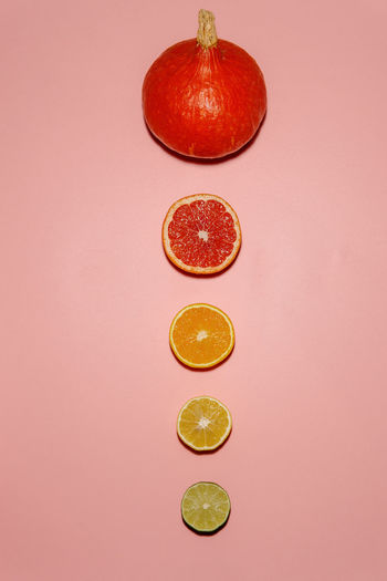 Fruits in glass against colored background