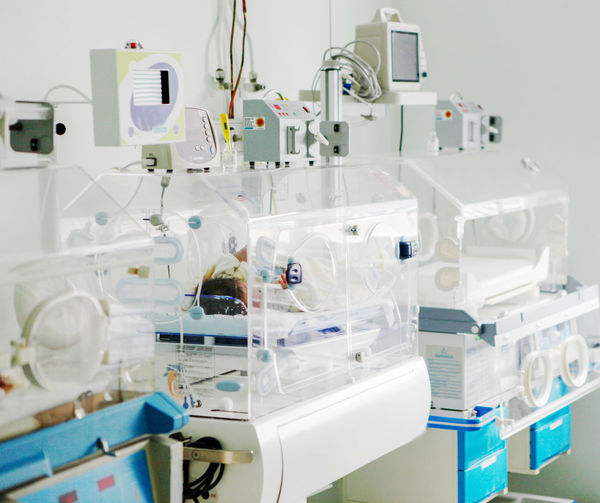 Newborn baby in hospital incubator