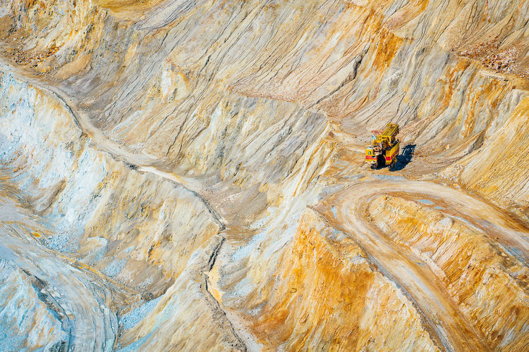 High angle view of mining vehicle on rock in quarry