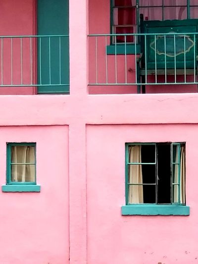 Low angle view of pink windows on building