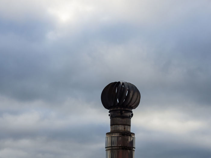 Low angle view of communications tower against sky