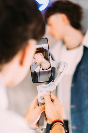 Photoshoot with mobile trendy teenagers
