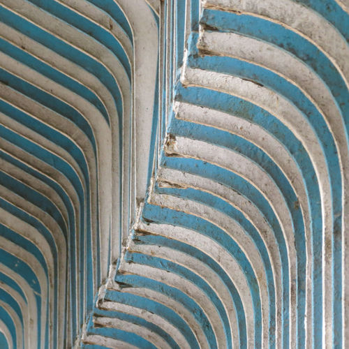Angled view of a blue and white fence