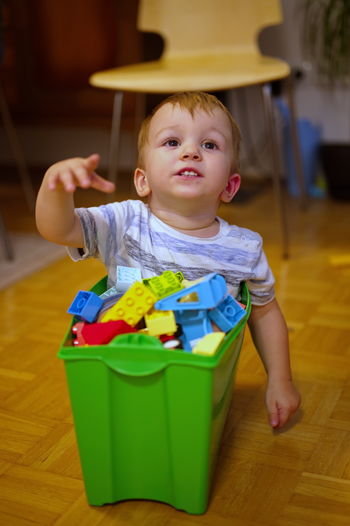 Portrait of cute boy playing with toys on table