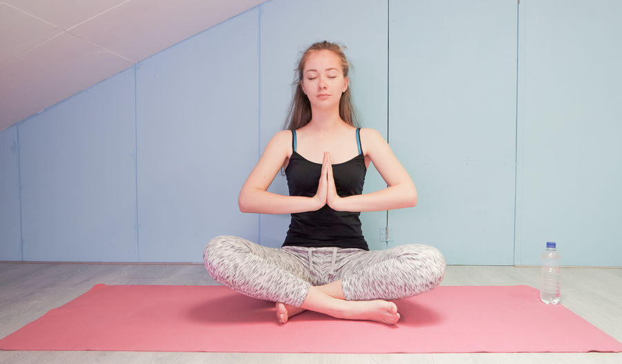 Young woman doing yoga at studio