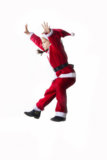 Low angle view of man dancing against white background