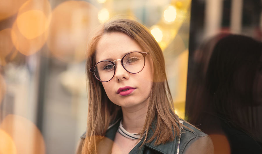Portrait of beautiful young woman wearing eyeglasses