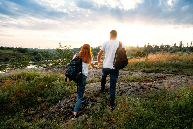 Local travel, solo explorers, small group tourist. young couple going for hiking, walk in nature. 