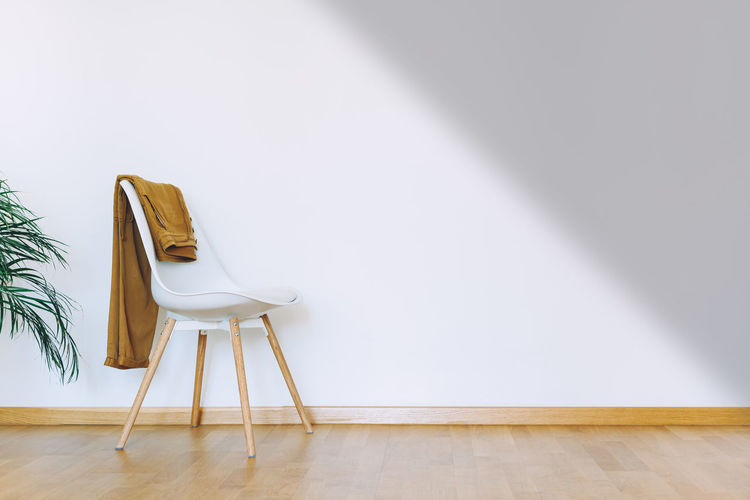 Empty chairs and tables against wall at home