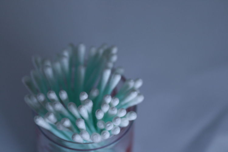 Cotton swabs in glass on table