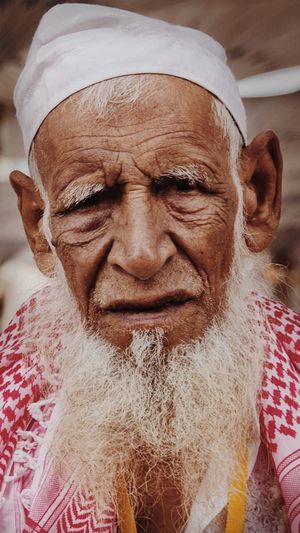 Close-up portrait of bearded senior man