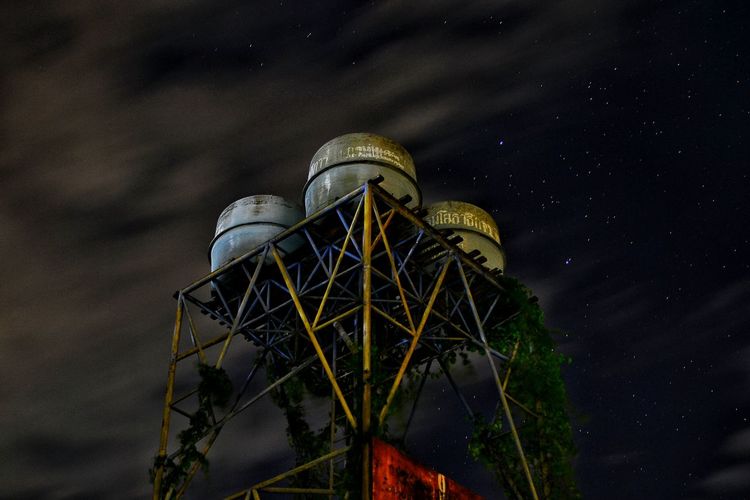 Water tower against sky at night