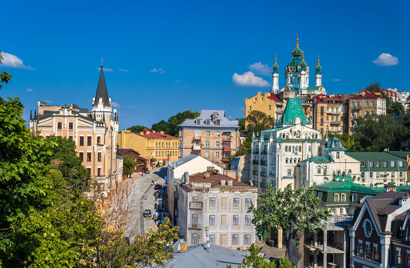 Buildings in city against blue sky