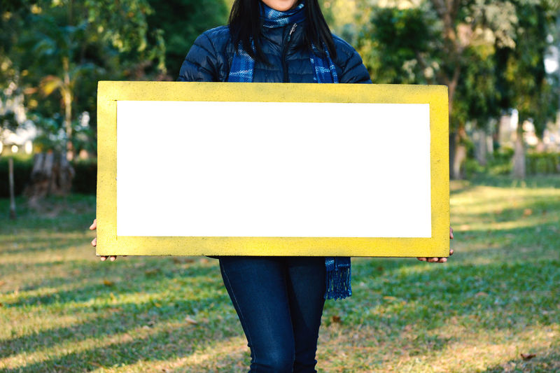 Woman holding blank placard
