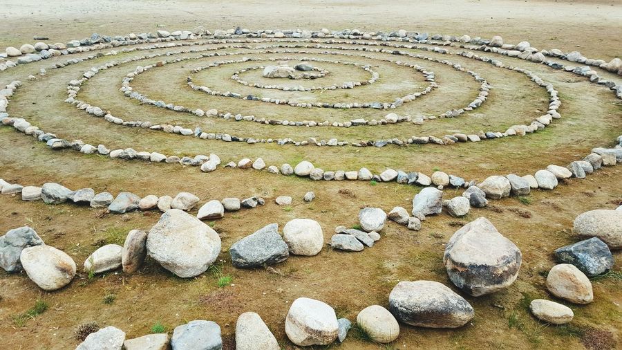 Labyrinth of rocks on field