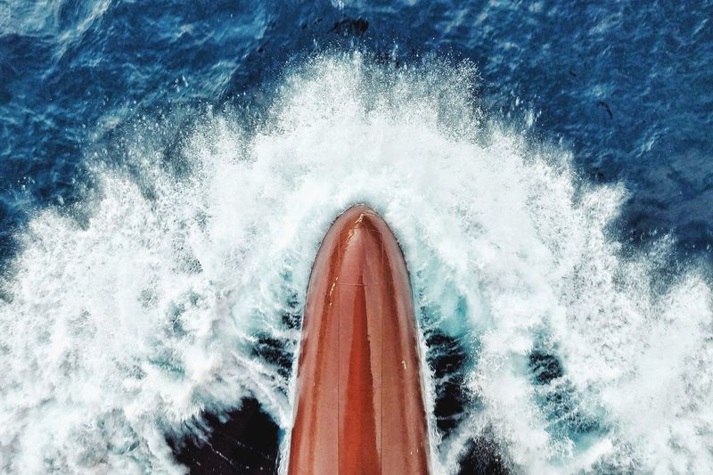 Cropped image of boat sailing in sea