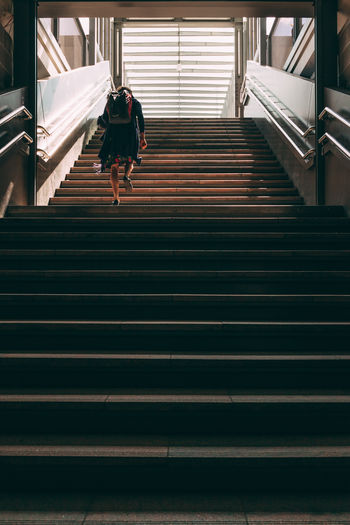 Low angle view of woman walking on stairs