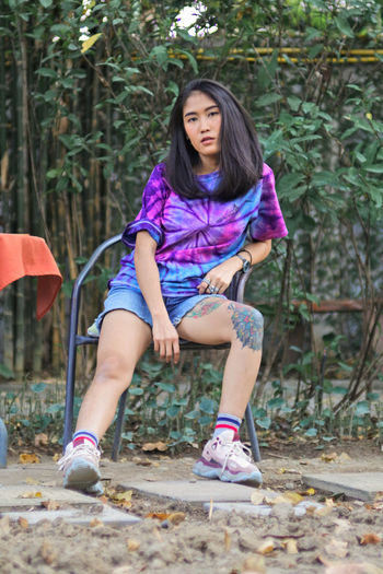 Portrait of a teenage girl sitting on land