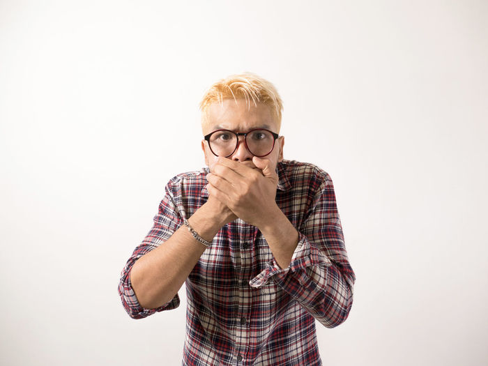 Portrait of mid adult man against white background