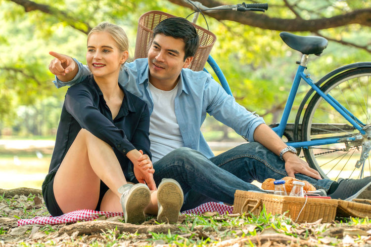 Young couple sitting on basket