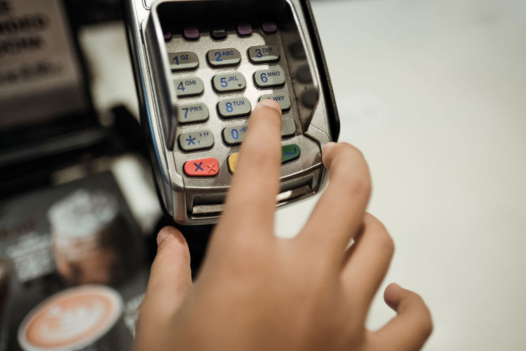 Close-up of person using credit card reader
