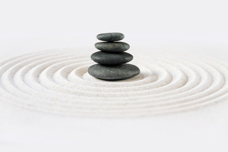 Stack of stones on white surface