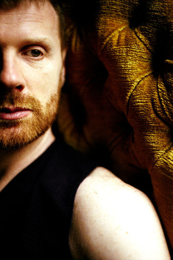 Young red hair bearded man portrait closeup, front view with natural light