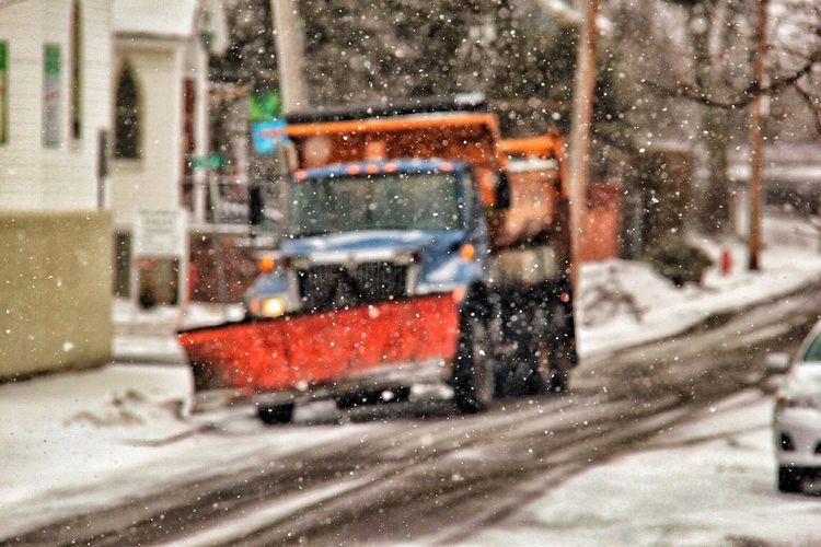 Snowplow on road during snowfall