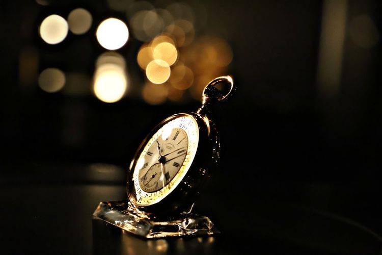 Close-up of pocket watch on table