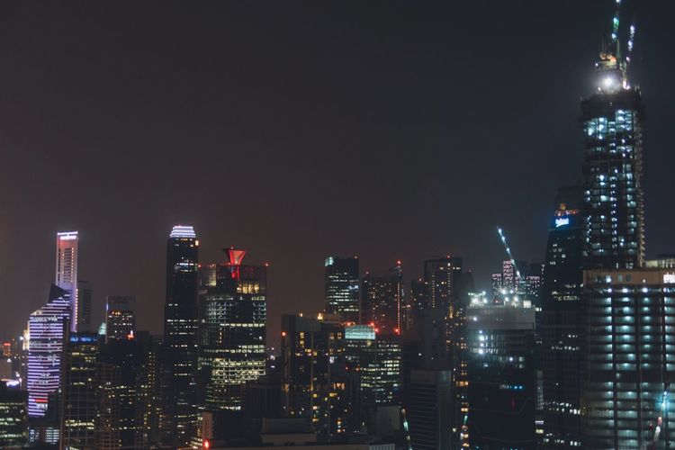 Low angle view of illuminated cityscape at night