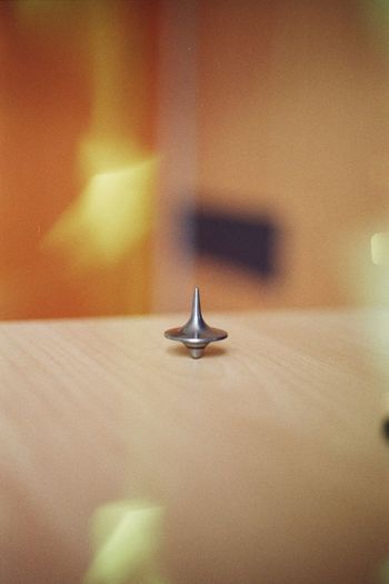 Close-up of spinning top on table