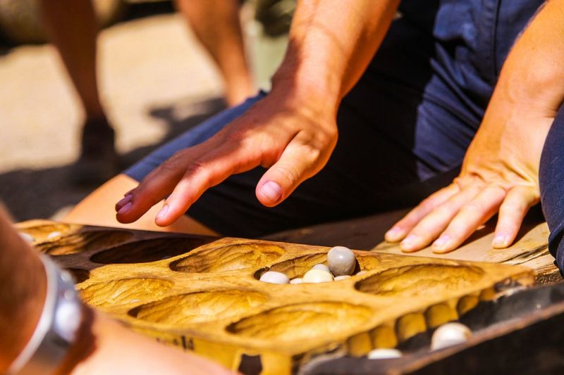 Midsection of people playing game on street in city