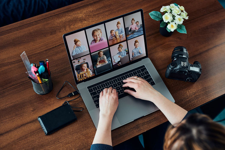 Female photographer working on photos on laptop and camera. woman editing retouching browsing photos