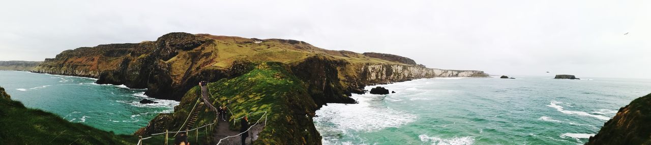 Panoramic view of sea and cliff against sky