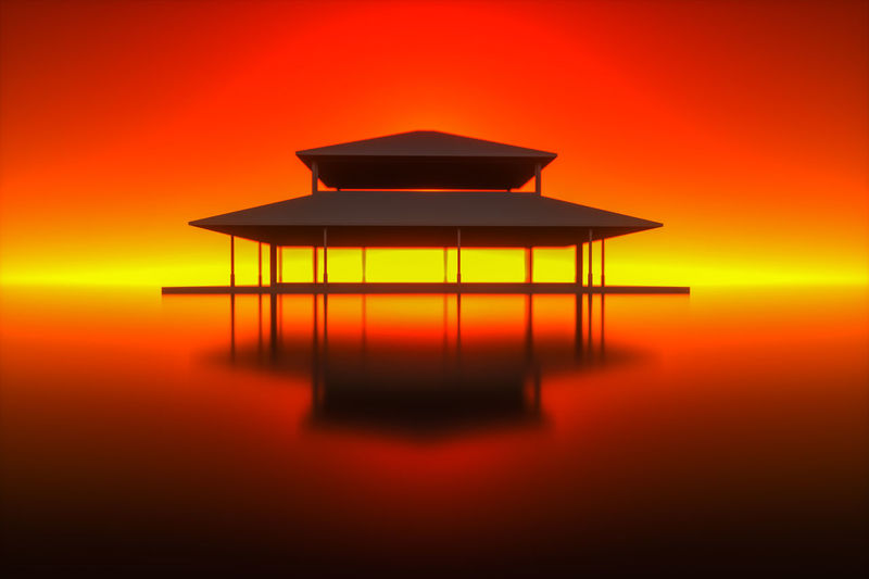 Silhouette built structure by sea against orange sky
