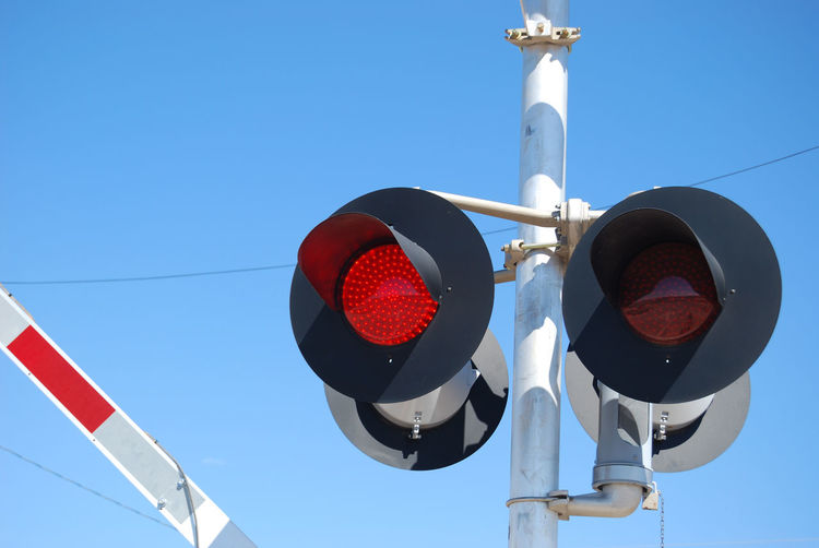 Low angle view of pole against blue sky
