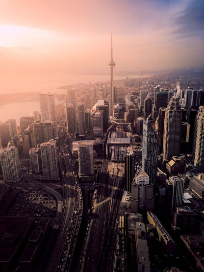 High angle view of buildings in city during sunset