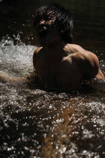 Portrait of shirtless man in water