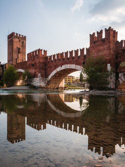 Castelvecchio bridge in verona reflecting on the adige river