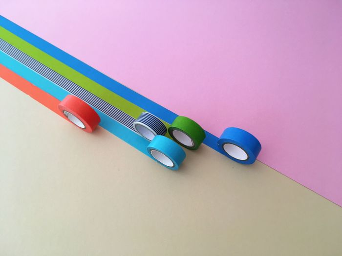 CLOSE-UP OF COLORED PENCILS ON WHITE TABLE