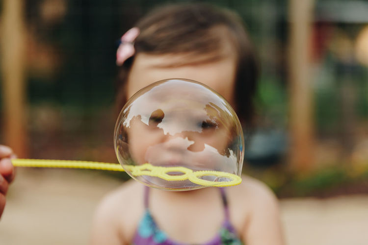 Close-up of girl seen through bubble