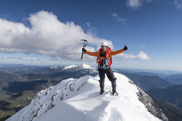 Full length of person on snowcapped mountain against sky