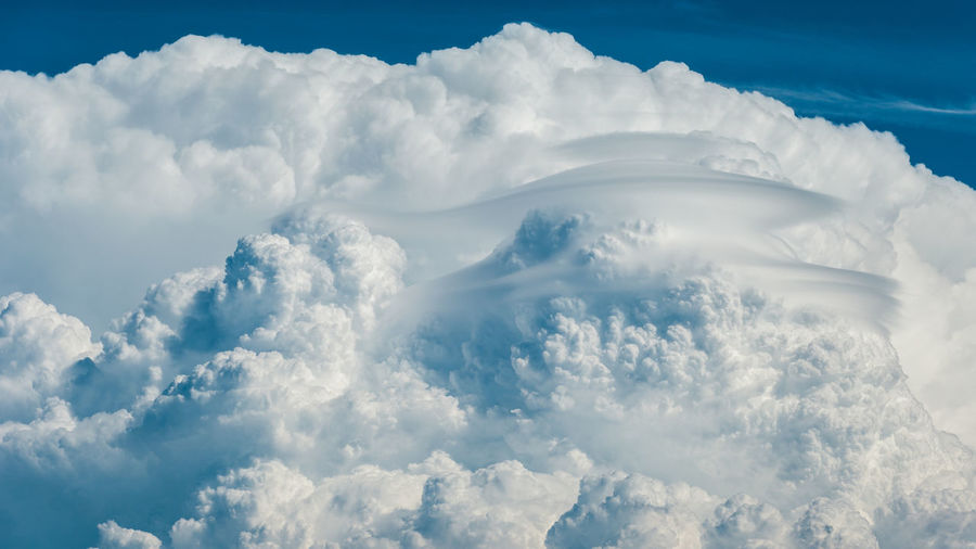 Exploding convection of a storm with pileus clouds.