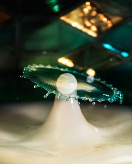 Close-up of drop falling on table
