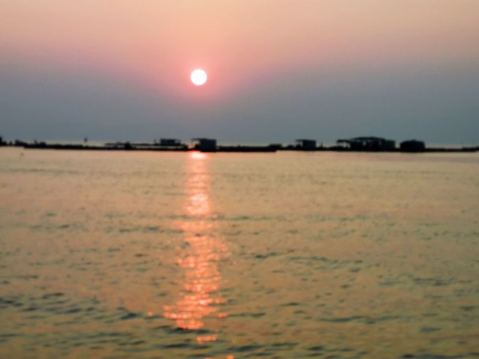 Scenic view of sea against orange sky