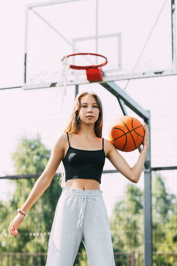 Portrait of young female basketball player. beautiful teen girl playing basketball. 