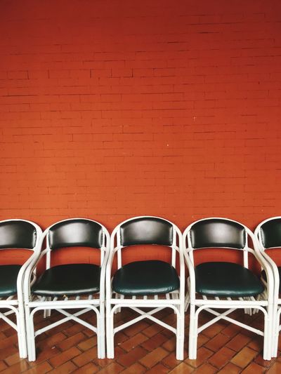 Empty chairs against wall